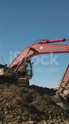 Bucket of backhoe digging soil at construction site. Crawler excavator digging. Excavating machine