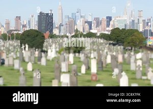 New York City Calvary cemetery in Queens, USA. Manhattan Midtown urban skyline cityscape buildings architecture. Many tombstones on graves, huge graveyard. Large cemetry in United States. Grass lawn Stock Video Footage - Alamy
