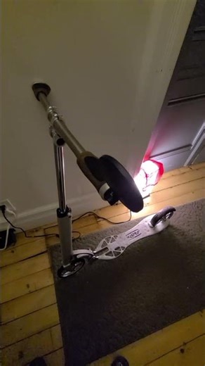 Snow covered Xootr Stingray kick scooter returning from winter shopping ride (12.2025)