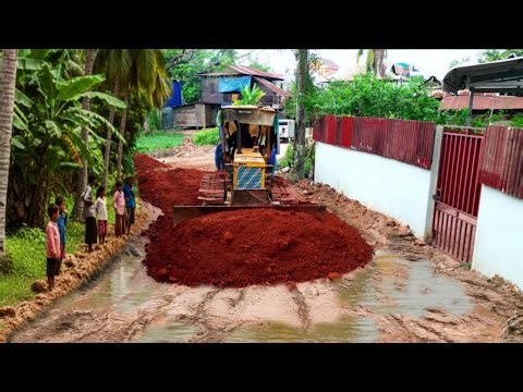 Nicely video skill bulldozer spreading soil to build strong road in village & dump truck unloading