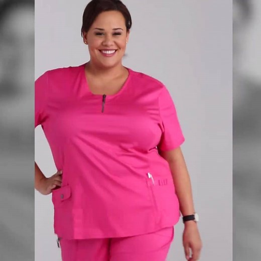 We love our Mia top, especially in this vibrant Pink color - a Beyond Scrubs classic! The front zipper is such a fun detail while the pockets and mesh panels add comfort and functionality. | Scrubs & Beyond