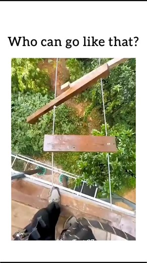 REEL HUB on Instagram: "Video Overview The video features a first-person perspective (POV) of an individual navigating a high-altitude ropes course or "sky walk" suspended high above a lush tropical forest. The climber moves across a series of swinging wooden planks with impressive speed and confidence. Key Highlights The Obstacle: The path consists of narrow wooden slats hanging from vertical ropes. Unlike a solid bridge, these planks are disconnected and sway freely as the climber steps on the
