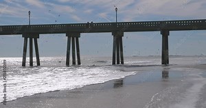 Fishing Pier over the waves and surf at the North Carolina Coast, near Wilmington, NC