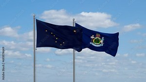 Maine and Alaska US state flags waving together on cloudy sky, endless seamless loop