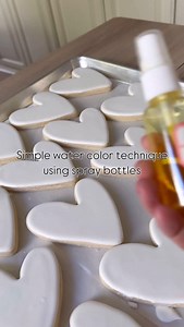 Turning airbrush colors into a watercolor effect with just a spray bottle. A little mist, a little movement, and the most beautiful soft blend on sugar cookies. Want to try this technique? Just mix airbrush color with a bit of water or Everclear, lightly spray, and watch the magic happen. Would you use this on your cookies? Let me know below! | The Cookie Curator, LLC