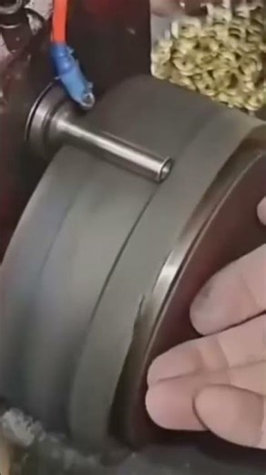 A small iron rod that is being bent using an advanced machine neatly