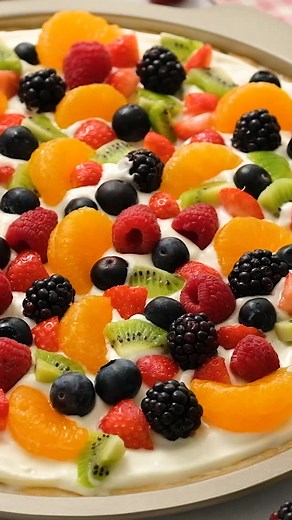 This amazing Fruit Pizza is a guaranteed crowd-pleaser! It features a delightful sugar cookie crust, a smooth cream cheese frosting, and a vibrant topping of your favorite fruits. It’s easily one of the most colorful and popular dessert recipes around!🍓🫐🍊 Comment “recipe” to have the recipe link sent to your inbox for later! Make sure you are following me so you can get it! 📥 Ingredients Sugar Cookie Crust: 1 cup unsalted butter 1 cup granulated sugar 1 teaspoon vanilla 1 large egg ½ teaspoo