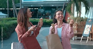 Women stand on street eating ice cream showing bright emotions Ice cream brings smiles joy. Ice cream delight in happy joyful friendship Savoring sweet flavors joyful moments together.