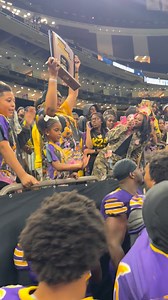 A touching moment as the mother of Corey Adams hoists the trophy, as Edna Karr wins back-to-back state championships . Her son, a former Karr star, was killed earlier this year during a shooting in Memphis, after committing to Ole Miss. | WDSU News