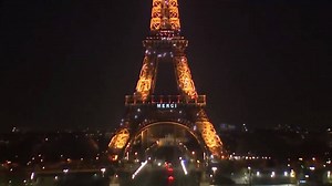 WATCH: Eiffel Tower lit up with the word "MERCI" to thank medical staff assisting in coronavirus response. | NBC Nightly News with Tom Llamas