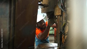 Maintenance engineer repairing a fuse box and electrical circuit.
