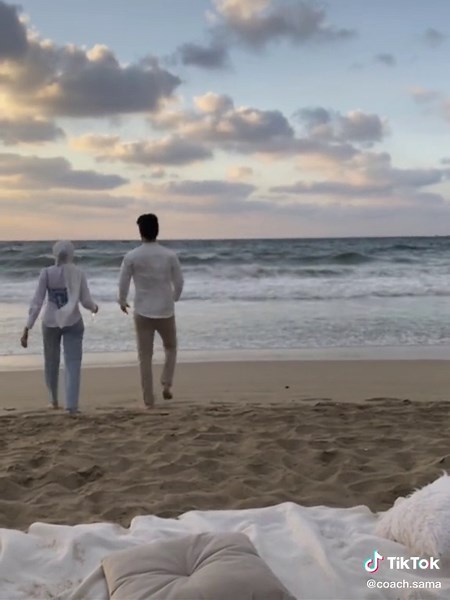 Romantic Beach Walk: Couple Enjoying Scenic Sunset