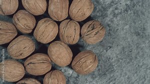 Whole walnuts in shells on dark background. Fresh organic nuts. Top overhead view.
