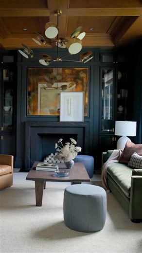 Just off the entry and formal dining, this parlor sets the tone for the home. The dark moody paint and rich wood tones create a sense of depth and calm. We reached for an earthy palette that feels both timeless and welcoming. A grounding sofa anchors the space beside a custom table by @dorosflooring that adds warmth and craftsmanship. This room invites you in and introduces the relaxed sophistication that carries throughout the home. Explore more of our interior design portfolio at marieflanigan