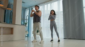 Couple man woman together sport training legs exercise home female male two people sportsman sportswoman physical activity athletes gymnastics squatting girl guy flexibility balance teamwork fitness