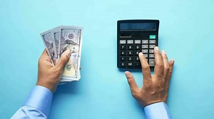 Top view of man hand using calculator