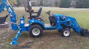 Setting the LS MT125 Subcompact Tractor with backhoe up for digging