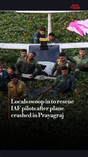 Two Indian Air Force (IAF) pilots had a narrow escape after their microlight aircraft was forced to make an emergency landing in a shallow wetland in Uttar Pradesh’s Prayagraj on Tuesday following a technical malfunction. The two-seater aircraft, which was on a routine training sortie, landed in waist-deep, muddy water choked with aquatic weeds, leaving the pilots briefly stranded before local residents helped rescue them. Witnesses said they heard a loud noise before seeing the aircraft crashin