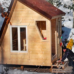 A wooden house in the middle of the forest. Construction in winter | Bushcraft Construction Technology