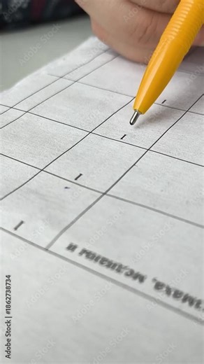 A woman accountant checks reports by running her hand and pen over paper documents. Economics, wages, taxes, calculations, statistics