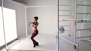 dance rehearsal in studio, woman in red suit is dancing alone, training new modern dance