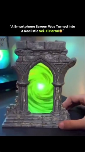 Cover Sphere on Instagram: "A simple smartphone screen becomes the heart of a convincing sci-fi illusion with nothing more than smart design and creativity. A 3D-printed stone arch frames the phone perfectly, turning the glowing display into what looks like a swirling portal rather than a flat screen. The textured arch adds real depth and weight, while the animated vortex on the phone creates the illusion of endless space beyond it. Placed inside an RGB-lit setup, the contrast between solid stru