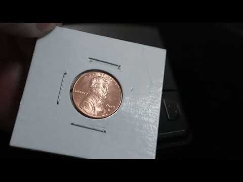 Weighing counterfeit coins trapped in holders
