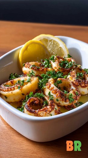 Grilled Calamari with Lemon & Parsley A refined coastal dish celebrating simplicity and balance, tender calamari kissed by the grill, brightened with lemon and finished with fragrant parsley. Light, fresh, and undeniably Mediterranean. Ingredients: 14 ounces calamari rings (fresh or cleaned) 2 tablespoons olive oil 2 garlic cloves, minced Juice of 1/2 lemon (plus extra wedges for serving) Salt and freshly ground black pepper, to taste 1 tablespoon fresh parsley, finely chopped Extra virgin olive