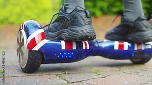 Young boy playing on motorized hover board in the garden