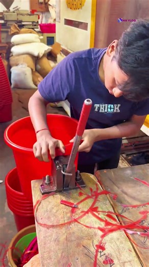 Watch the machine make red plastic buckets