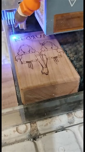 Laser engraving the Grady Twins from The Shining on a dugout. | A GreenFoxx