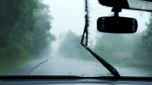 Download Car front view with wiper moving in heavy rainfall for free