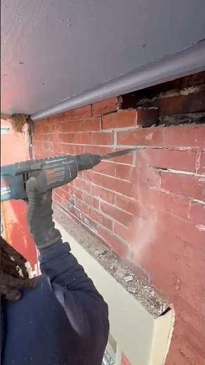 Using a Bosch hammer drill in chipping mode to loosen the brick and start demo.#work #construction