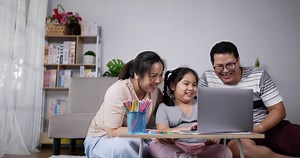 Download Parents Teaching Little Daughter Use Laptop Computer for free