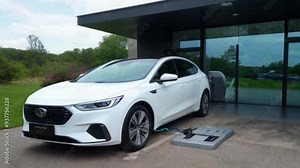 Power supply for electric car charging loading in Home . Electric car charging station. Close-up of the power supply plugged into an electric car being charged.