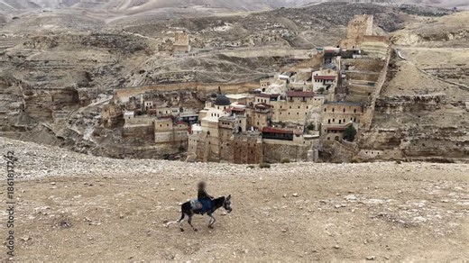 Child Riding Donkey Near Mar Saba Drone footage of an unidentified child riding a donkey with Mar Saba Monastery in the Judean Desert background, November 2025, Israel