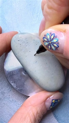 3.1K views · 345 reactions | Day 3 of #blue_inktober2025 and #RIL_pattern on a pebble. I’ve barely drawn this pattern from the moment it’s been adda to my 3rd deck, Grids&Ribbons. But now it falls into the first chapter of my e-book: focal patterns. ✨✨ #inktober2025 #paintedpebbles #paintedrocks #zenart #pattern_by_alena UniPin fineliners, POSCA pencils, UniBall Signo golden gel pen, spray varnish. The first sakura blossoms | Alena Light draws | Facebook