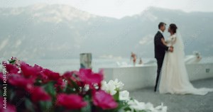 In amazing place in the middle of mountain and lake in Italia beautiful bride and groom happy hugging and kissing each other. Stock Video