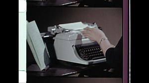 1970s Syracuse, NY. Woman typing on typewriter. Close up of female hands. Fingers touch on the keys short but firm as typist records data. 4K Overscan of Vintage Archival 16mm Film Print