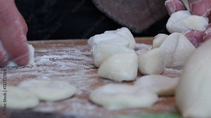Making traditional Chinese dumplings,press the doughs into a round disc