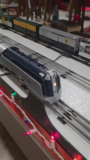 Reading Crusader Passenger train running on the o scale layout around the fire truck.