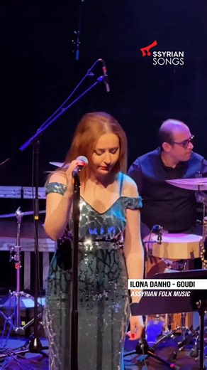 Ilona Danho - Goudi (Assyrian Folk Music) In a rustic setting, two women rhythmically churned butter, their voices harmonizing in song. They operated a traditional goatskin butter churn, known as a (Gutha), suspended from a sturdy wooden tripod. Creamy buttermilk, poured into the Gutha, was vigorously shaken back and forth between them. With each powerful sway, the buttermilk lipids gradually coalesced, transforming into rich, natural butter. | Assyrian songs