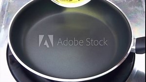 Pouring cooking oil into a cooking pan slow motion