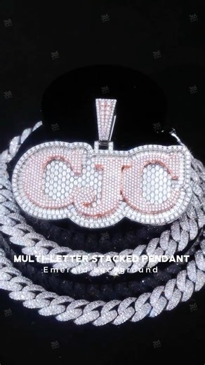 Custom365d on Instagram: "🔤Stacked multi-letter pendant designed with a bold layered structure and strong visual impact. Each letter features a thick, dimensional outline with clean edges for a premium custom look. The background is fully set with emerald stones, creating rich color contrast against the diamonds. The stacked layout gives names or initials a powerful presence and identity-driven expression. Start your custom order with just a $100 deposit and get a chance to receive a free chain