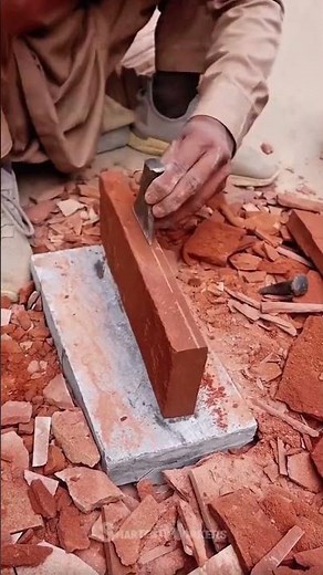 Using a chisel to cut a brick into two layers for tight installation and wall dynamic construction