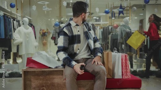 Man observes shopper quietly, Gentleman sitting patiently gazes at customer through shop window with interest
