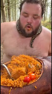 10K views · 65 reactions | A happy guy enjoying hot jollof rice in the jungle, calmly chilling with a python on his neck  But imagine a lion approaching from behind right now…  This unexpected moment shows why the internet loves AI-generated videos, wild scenarios, and funny twists. ⚠️ This video is AI-generated for entertainment purposes only. | Ezenkwa Tv | Facebook