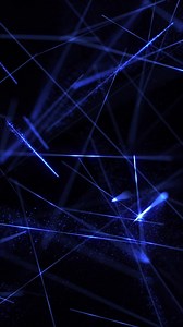 Download Vertical video - glowing blue laser beams motion background with shiny exploding particles and flashing fast moving lasers. This technology background animation is full HD and a seamless loop. for free