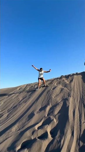 Sandboarder Wipes Out on Sand Dune