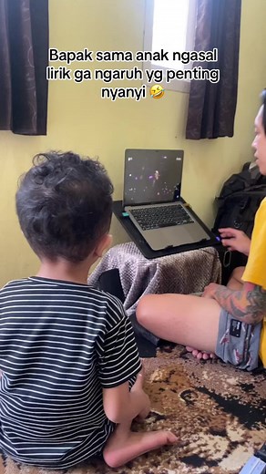 Child and Adult Interact with Laptop in Domestic Setting
